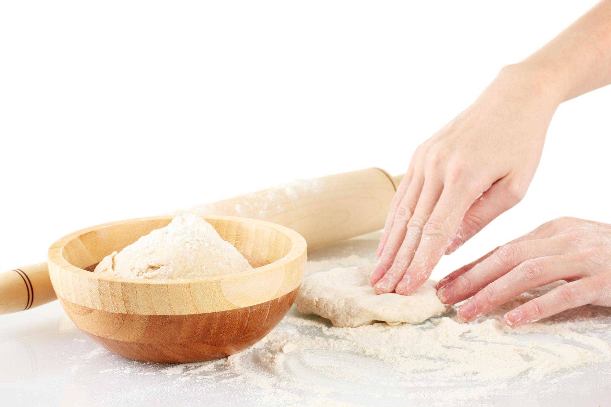 Close-up of hands kneading dough