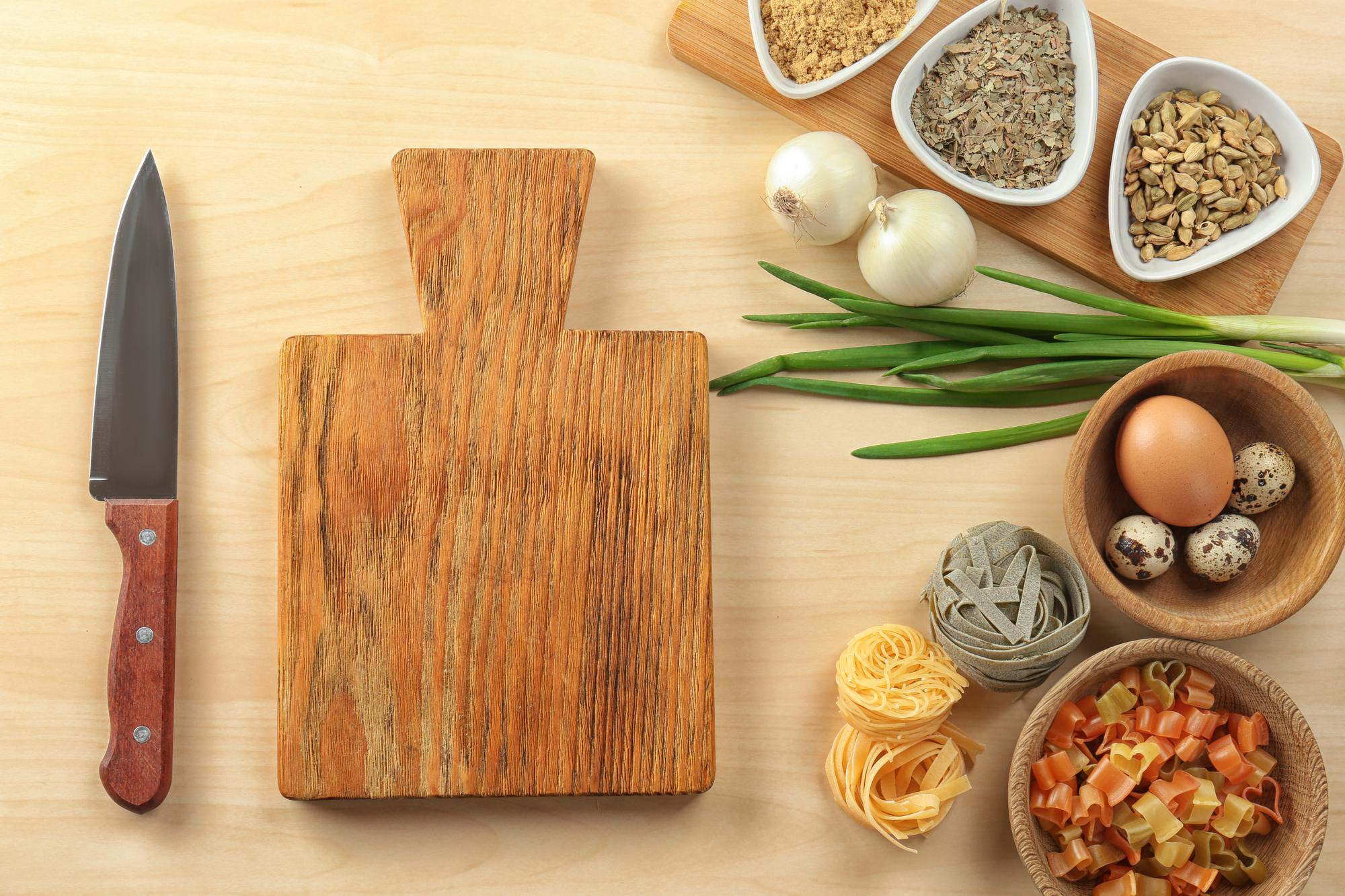 Small curated set of cooking tools on wooden board